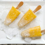 Mango popsicles on a plate with ice