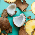 Coconut chunks and pineapple slices scattered